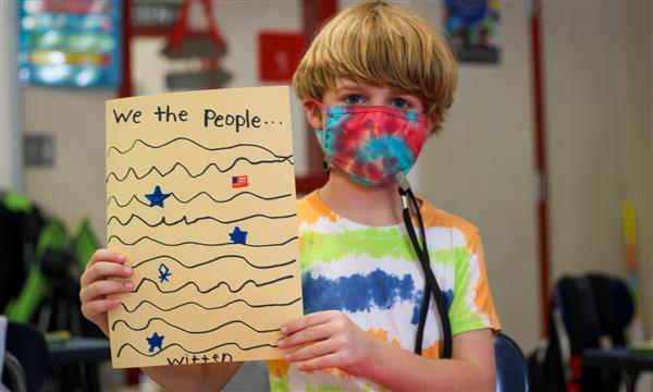 Boy holds up Constitution craft